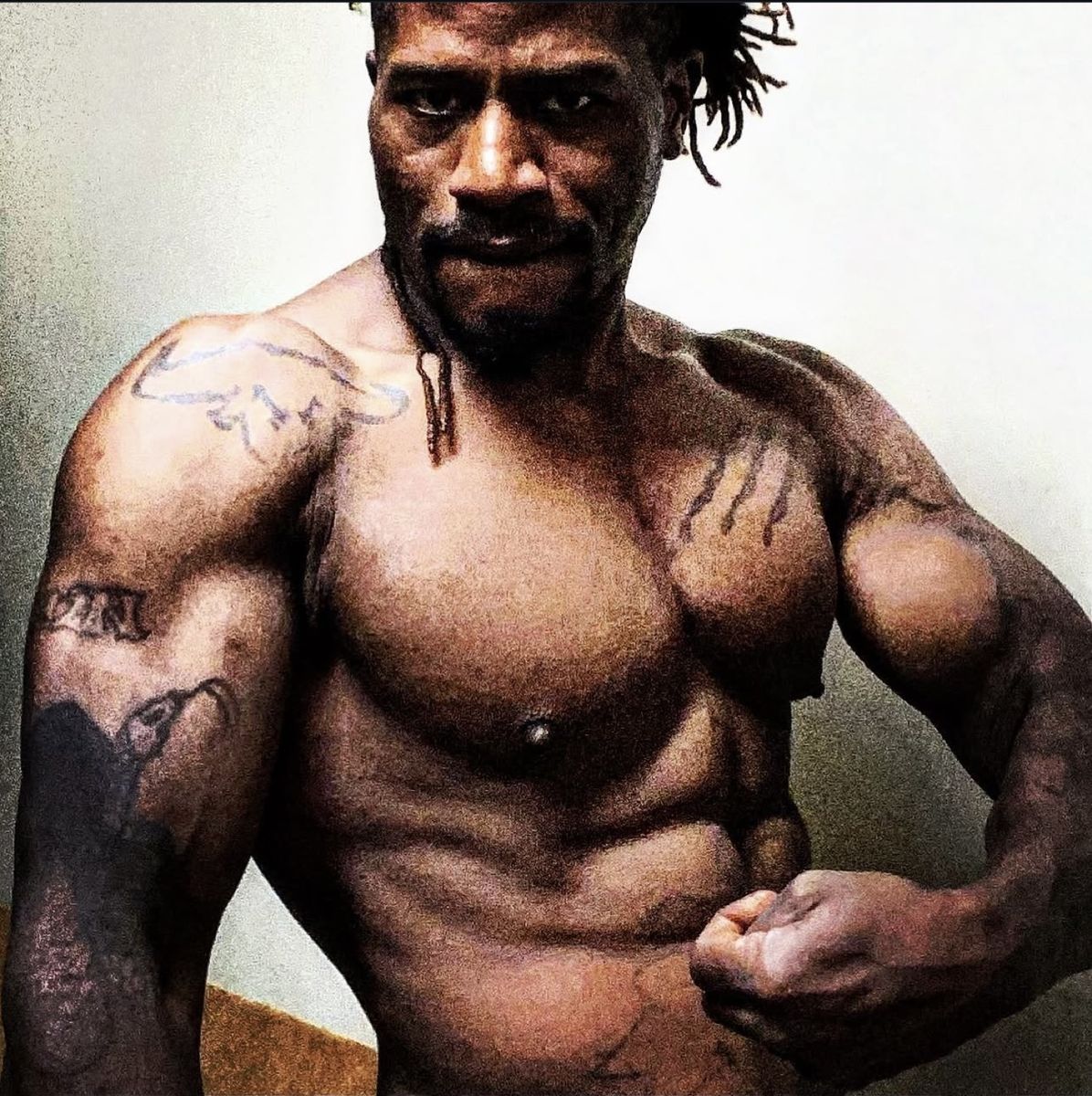 XL, male exotic dancer, flexing in a promo photo